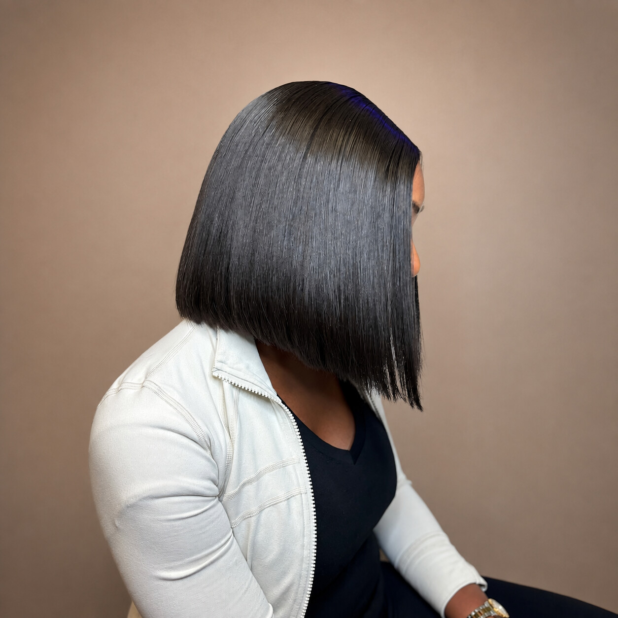 Tamed by Tan client with a sleek black bob