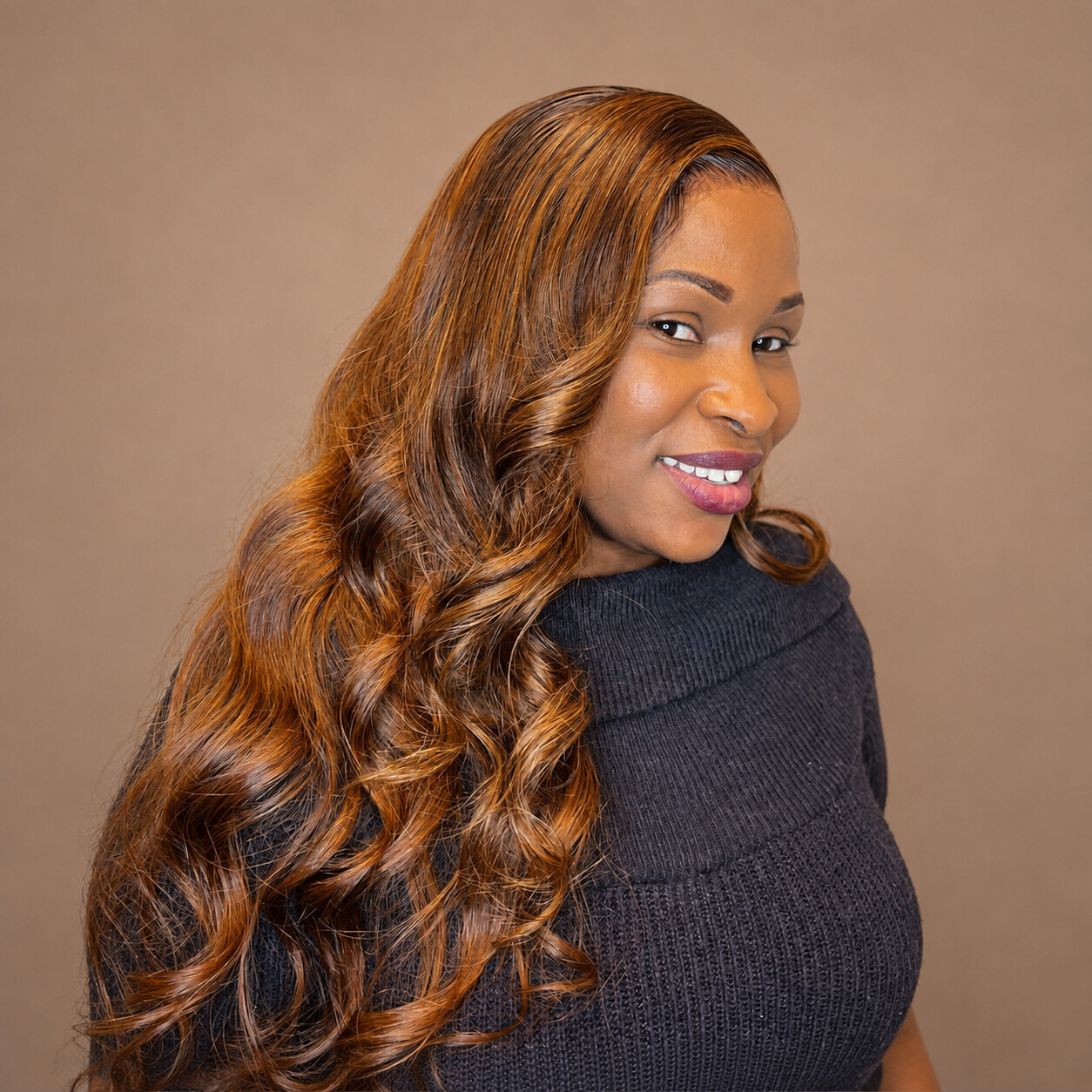Tamed by Tan client with long copper glamour curls