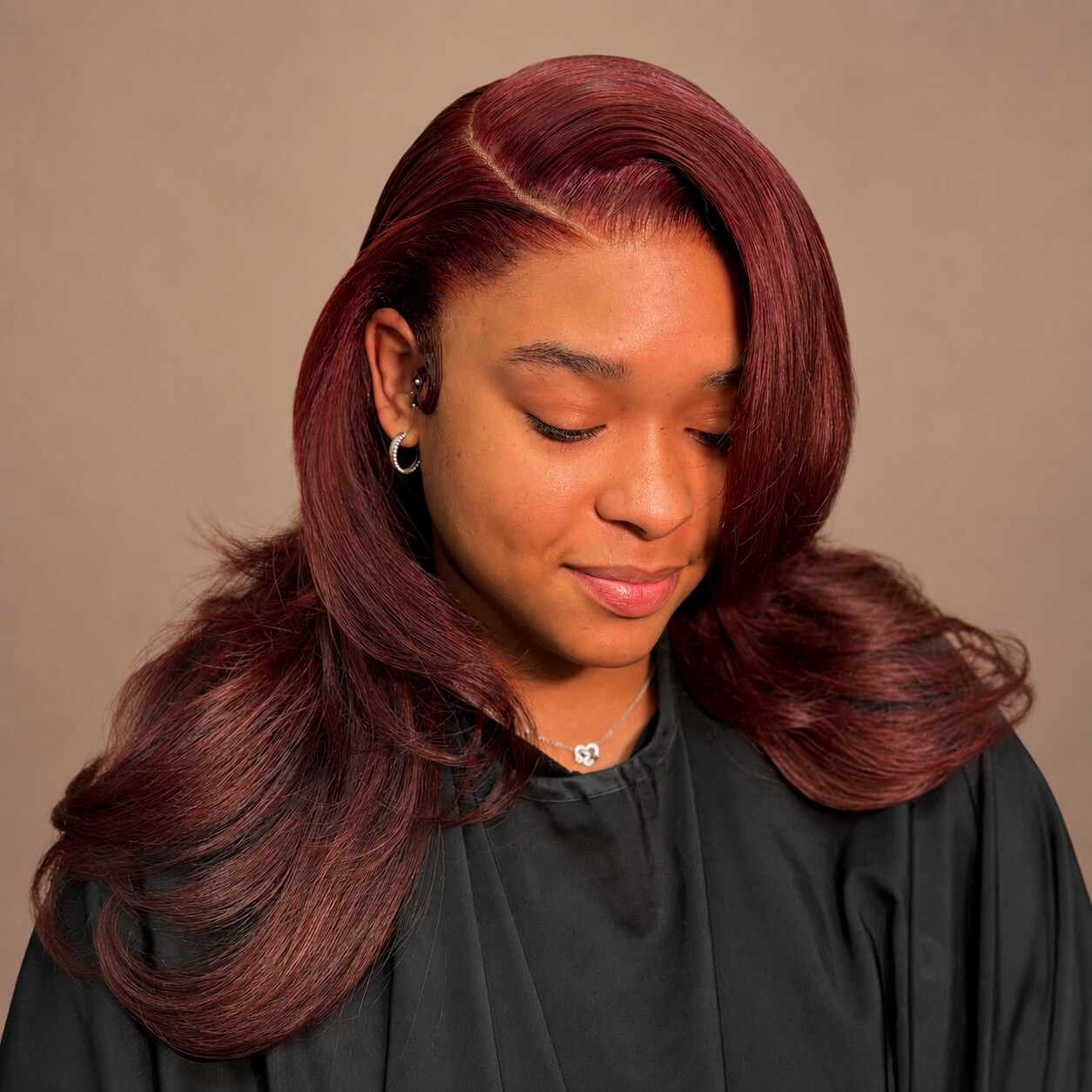 Tamed by Tan client with a burgundy side-part blowout
